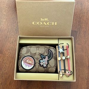 Brown Coach wallet with three Coach charm ties. Still packaged, never used!